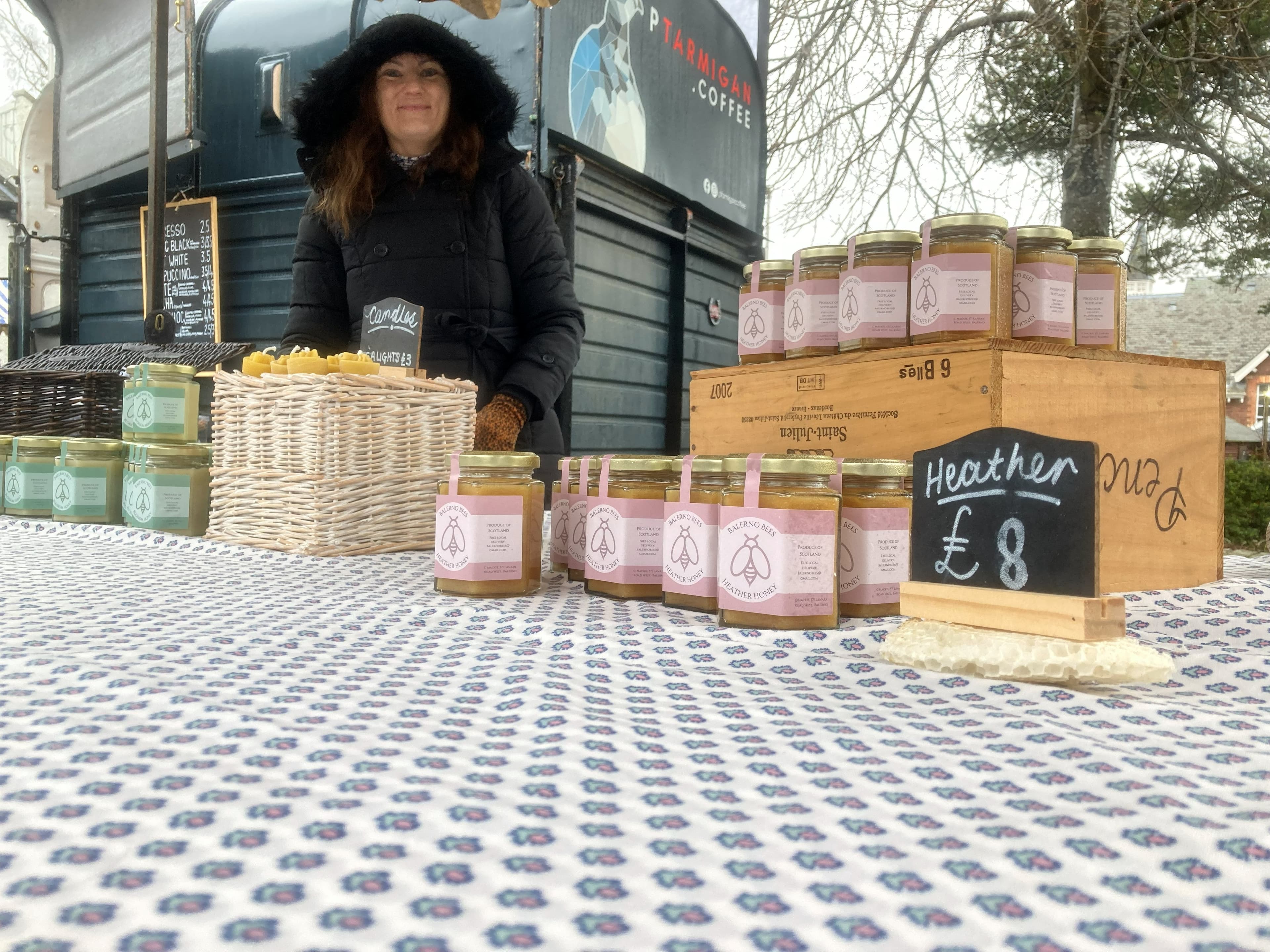 Balerno Bees at an Edinburgh farmers market Balerno Bees outdoor farmers market stall with rows of heather honey jars on display — an Edinburgh producer selling direct to local customers